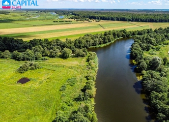 72 arų sklypas prie upės – gamtos grožis ir ramybė